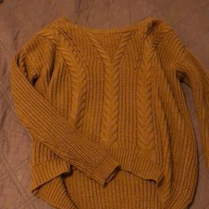 Orange sweater with cross in the back